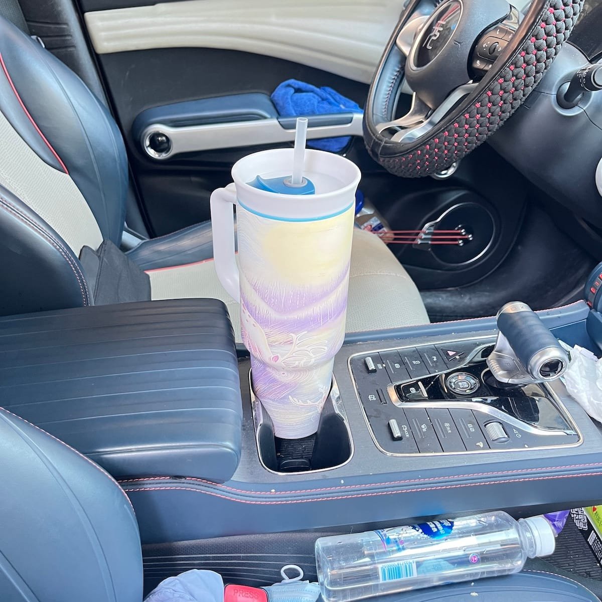 Walking on Water 40 oz dual-sip tumbler in a car cup holder during a drive
